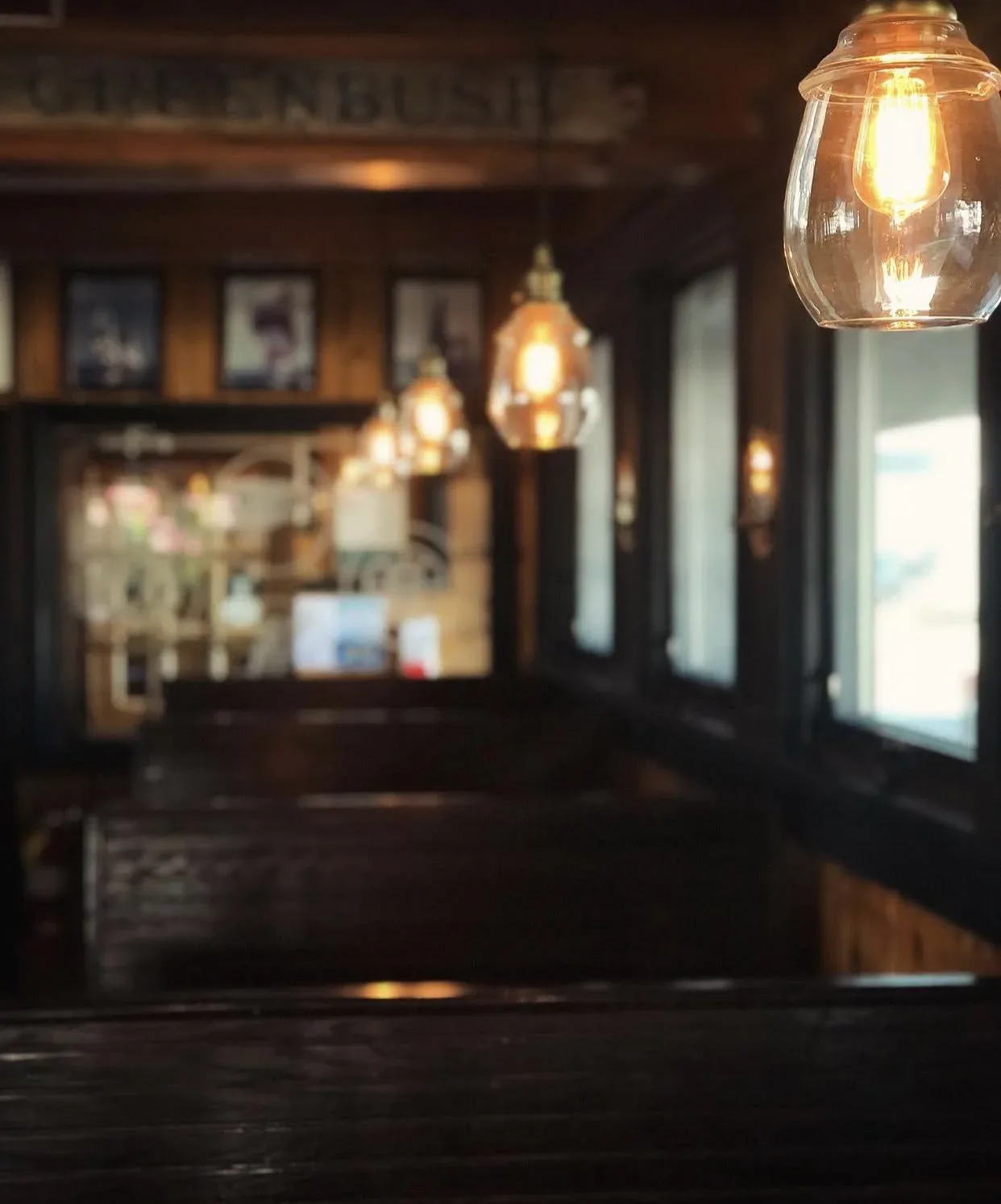Cozy interior bar at T.K.O. Malley's with warm Edison bulb lighting