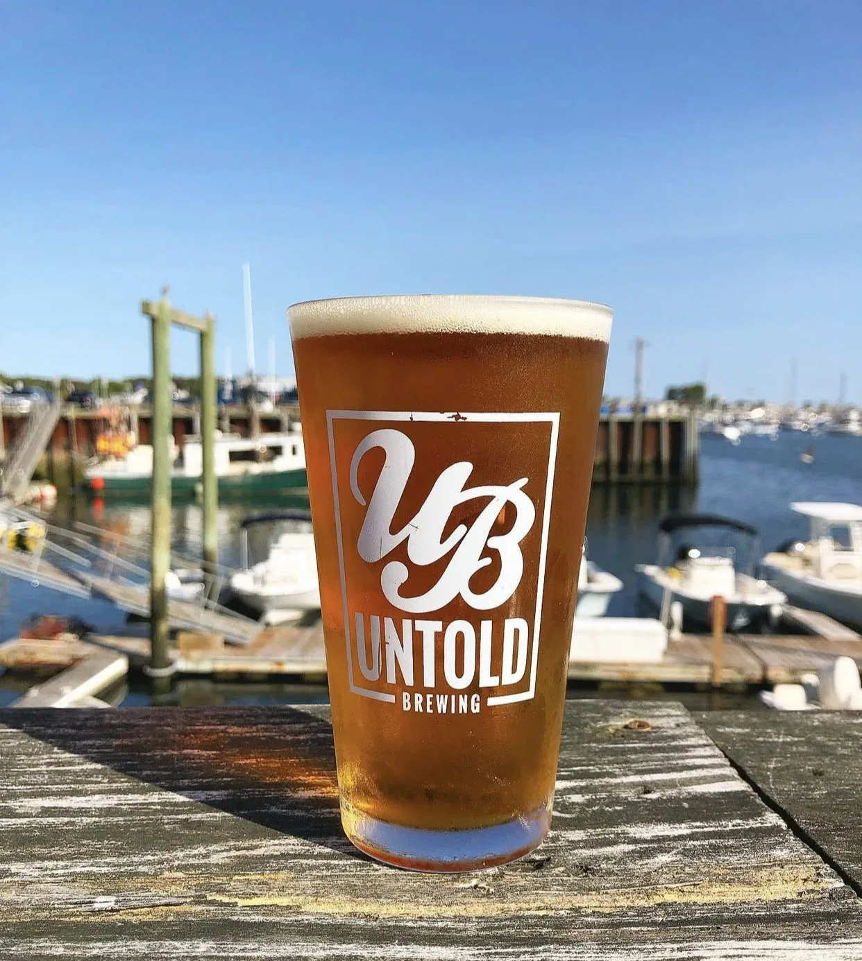 Untold Brewing pint glass on the dock at Scituate Harbor